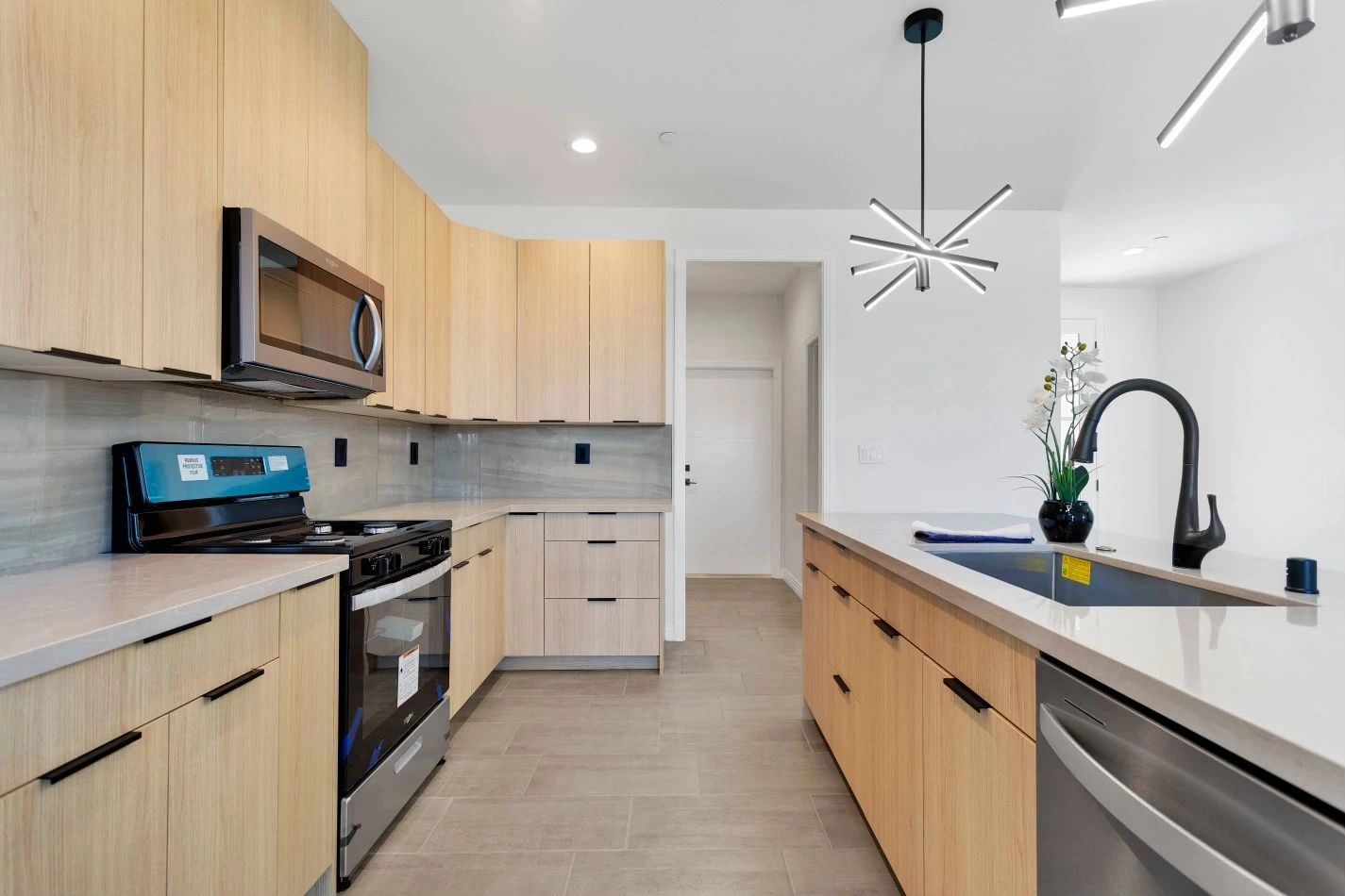 Two-tone kitchen with light wood cabinets