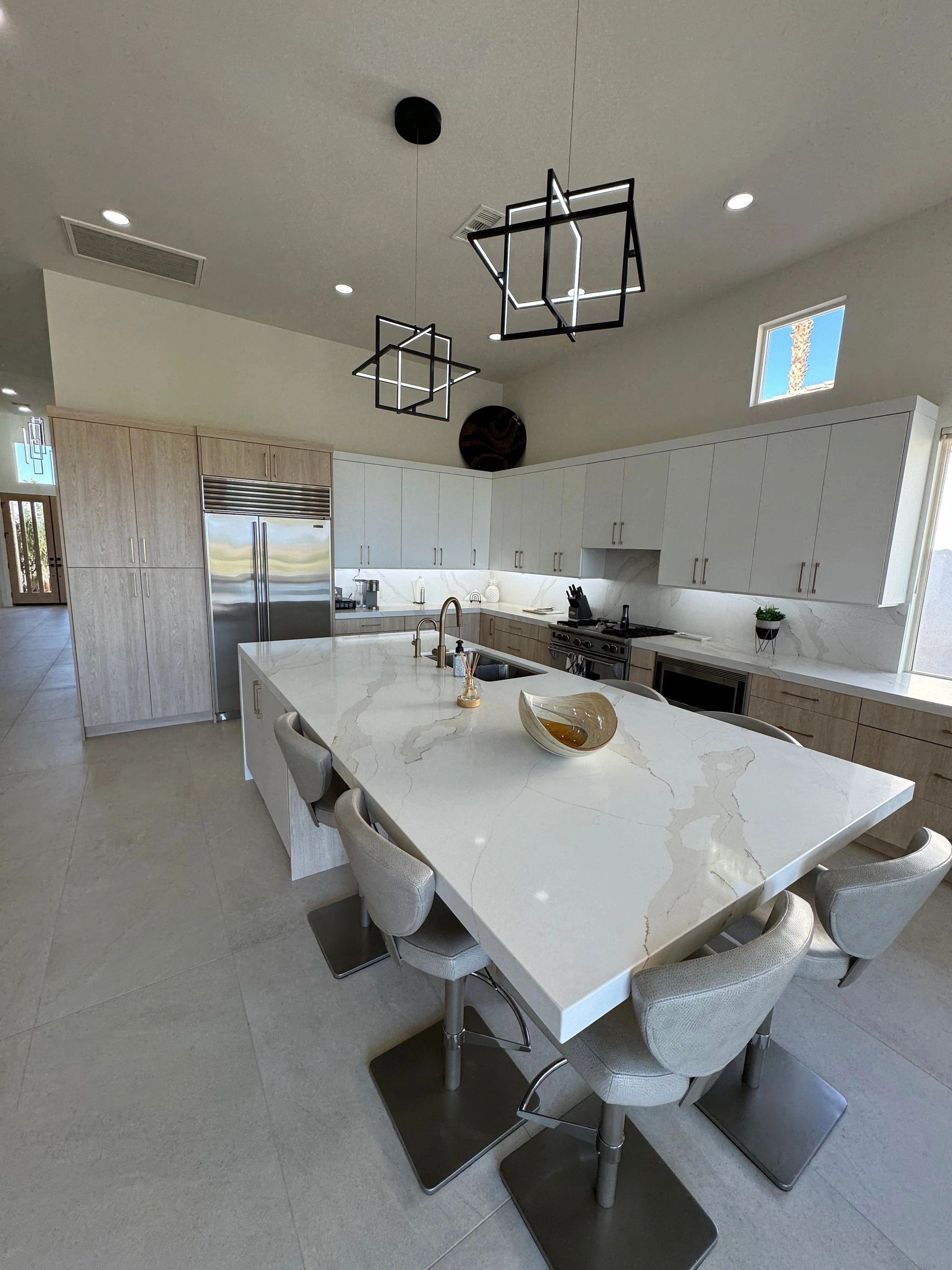 Modern kitchen with white quartz waterfall island