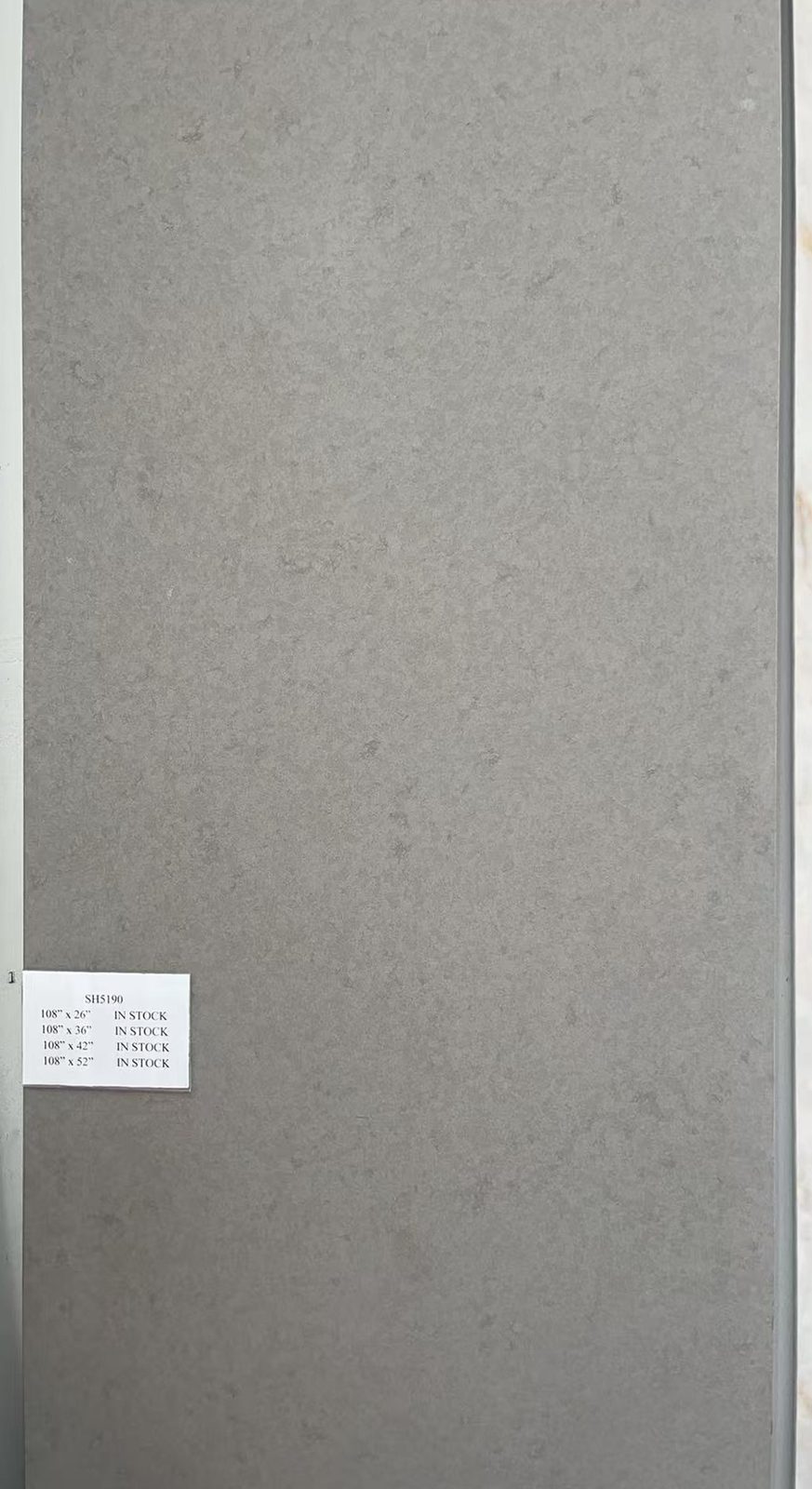 Solid concrete-gray quartz with a fine even texture. — full slab