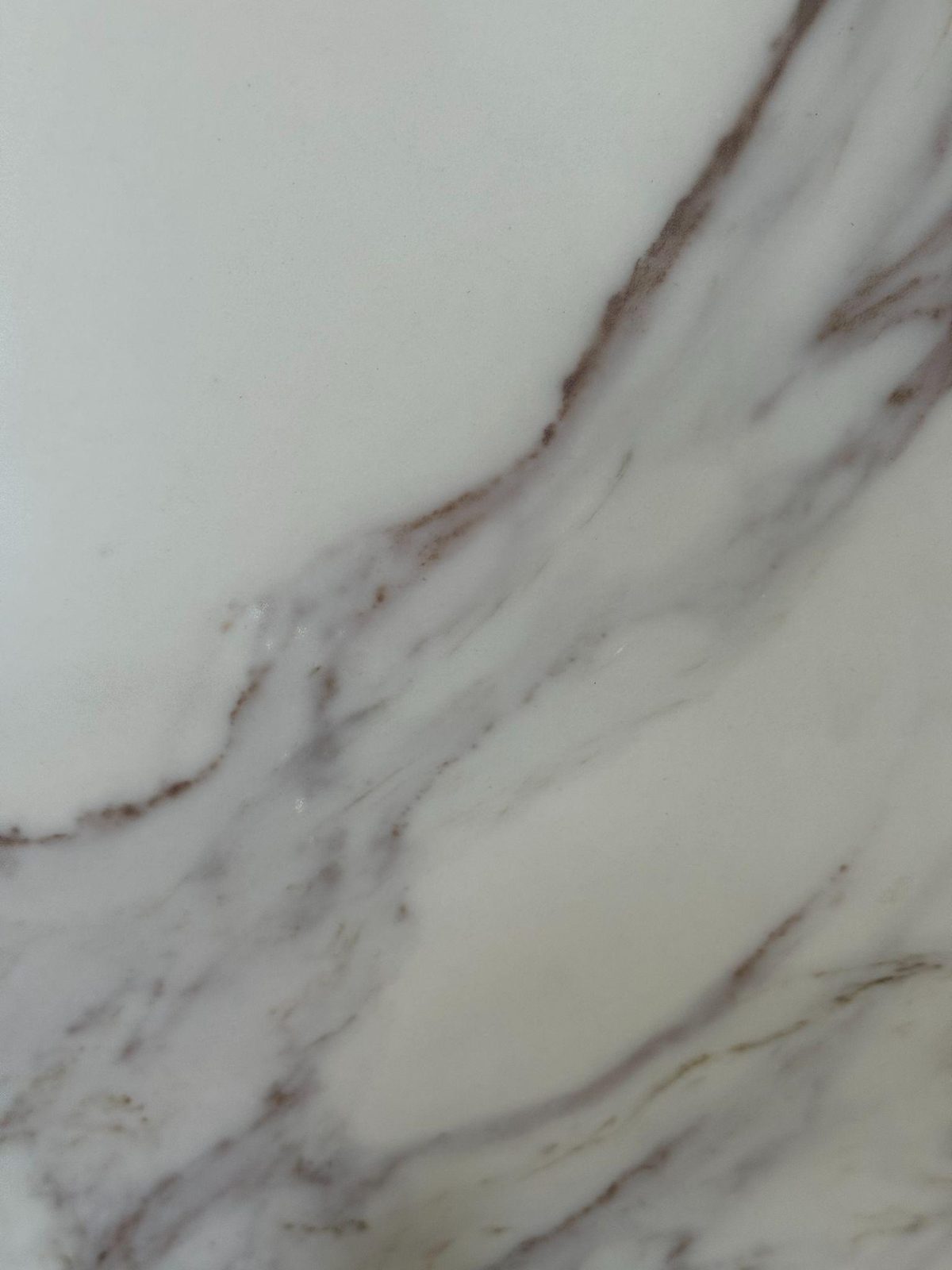 White marble with dramatic purple-gray and gold veining.