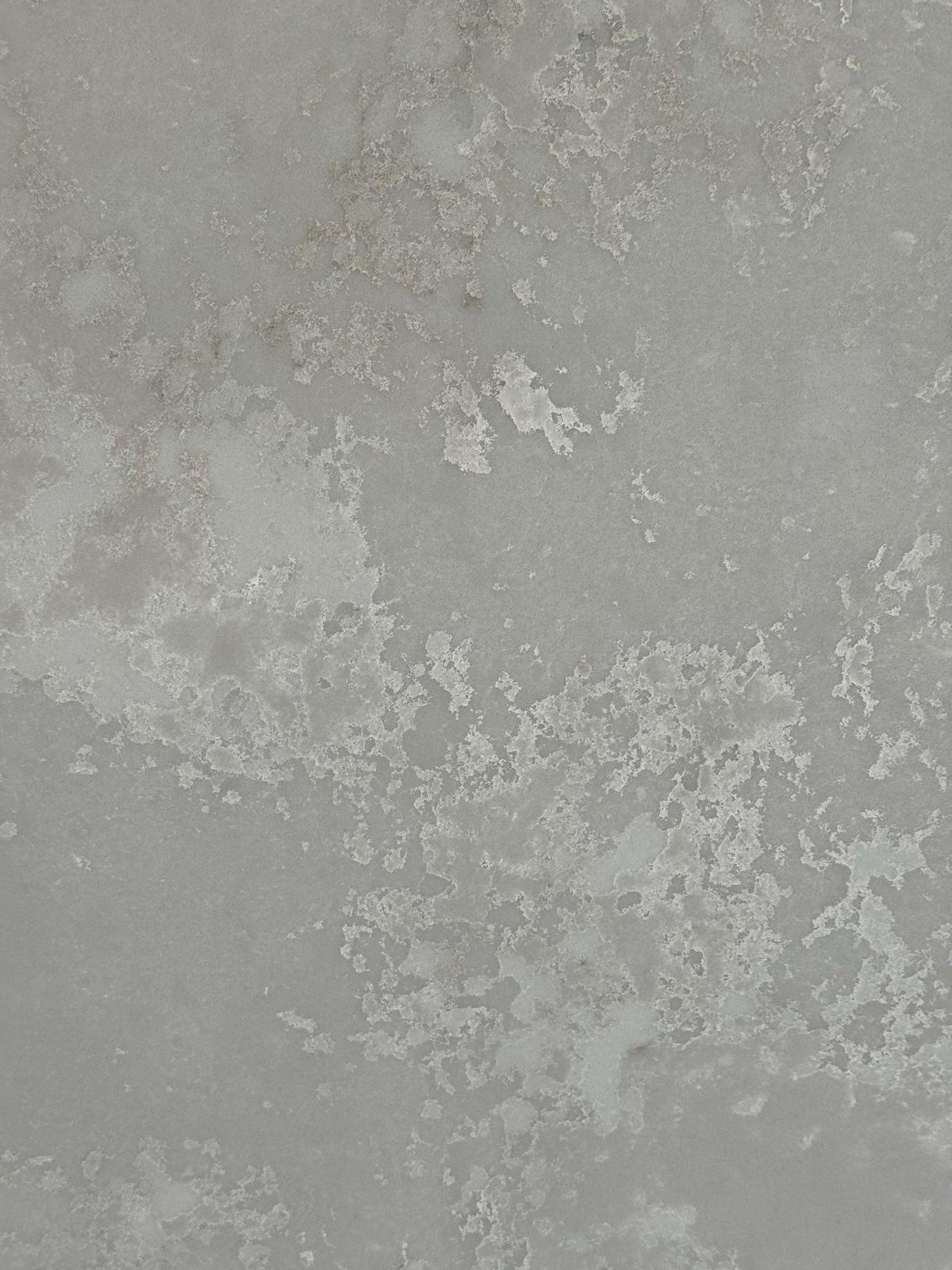 Warm gray quartz with cloudy mineral mottling.